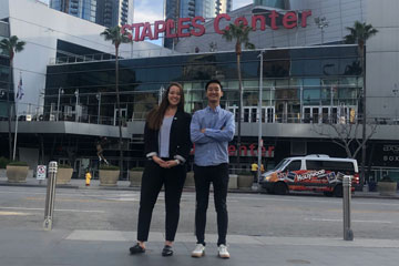 Seaver students Caitlin Fogg and Daniel Lee standing in front of the Staples Center