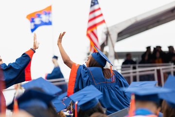 Students high-fiving during graduation