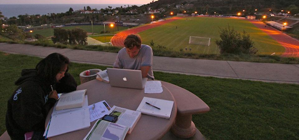 two Seaver students studying outside