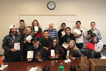 Students holding their books for the Econ reading group