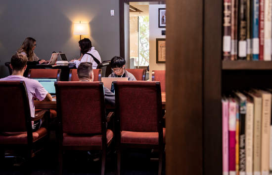 Pepperdine students studying at large tables in Payson library