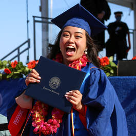Seaver student holding her diploma