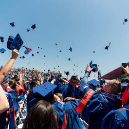 Students tossing their graduation caps in the air