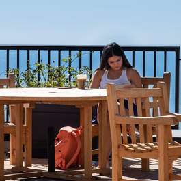 Seaver student working on the Sandbar patio