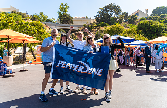 family with pepperdine flag