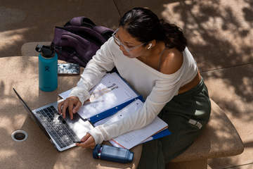 Seaver student on her laptop in Mullin Town Square