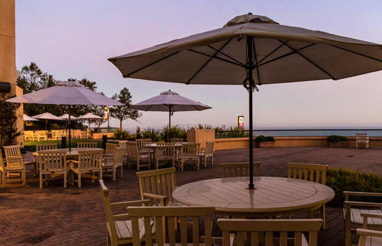 Tables with opened umbrellas on the Malibu campus