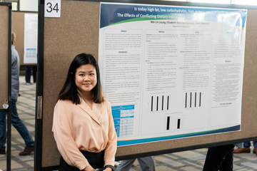 Seaver student in front of her research poster