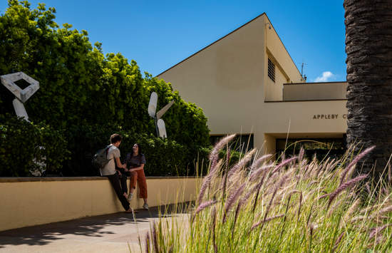 two students standing outside the Appleby Center on campus