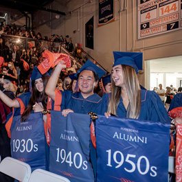 Students holding alumni banners at Founder's Day