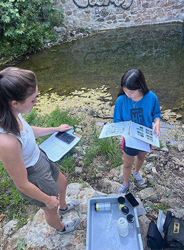 Students researching crayfish outside