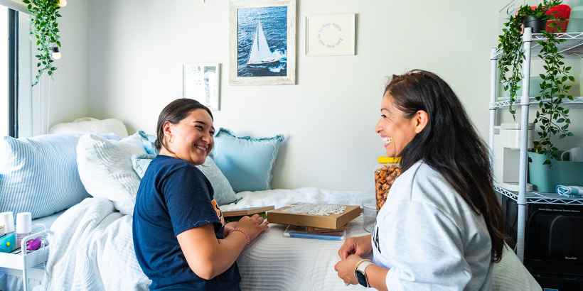 A mother and daughter smiling at one another