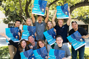 Seaver College admission counselors grouped together holding a sign that reads 