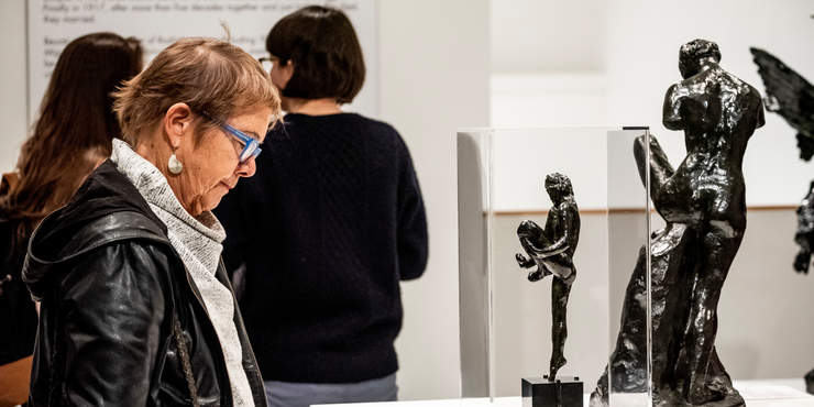 Female looking at a charcoal statue at the Weisman museum