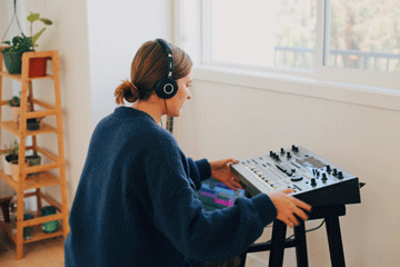 Seaver student listening to a sound board