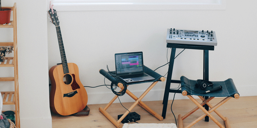 Guitar and other instruments standing against a wall