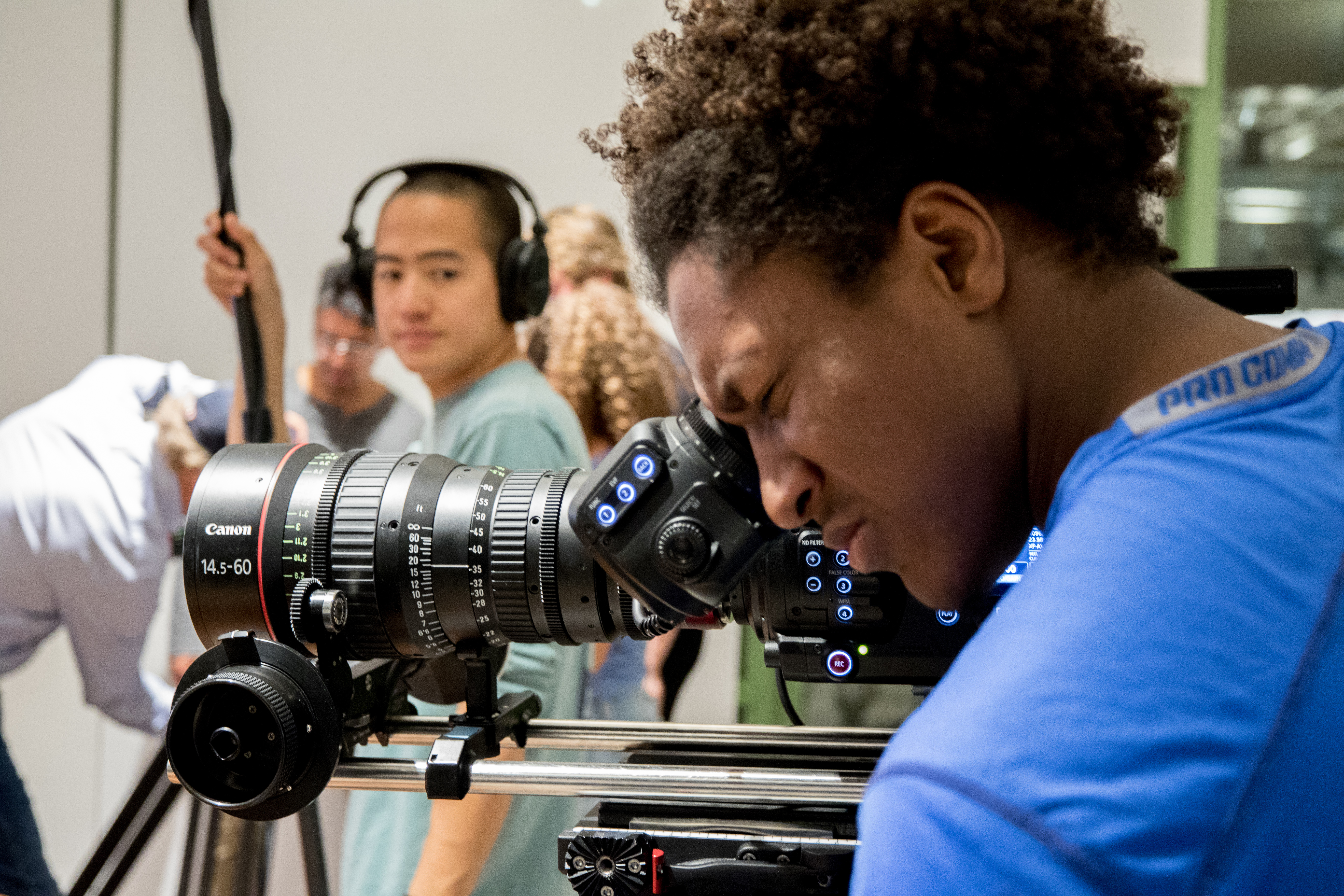 Seaver student looking into a Canon recorder lens piece