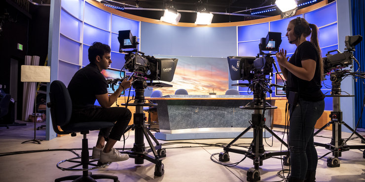 Seaver students on the production floor, preparing cameras for an upcoming NewsWaves broadcast