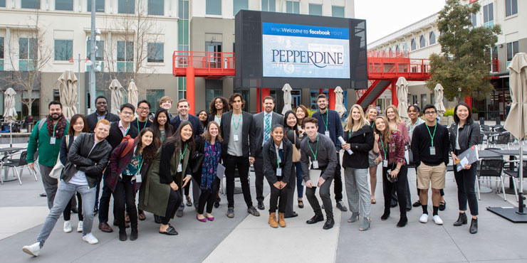 Seaver students standing outside a digital Facebook sign that says Welcome to Pepperdine 