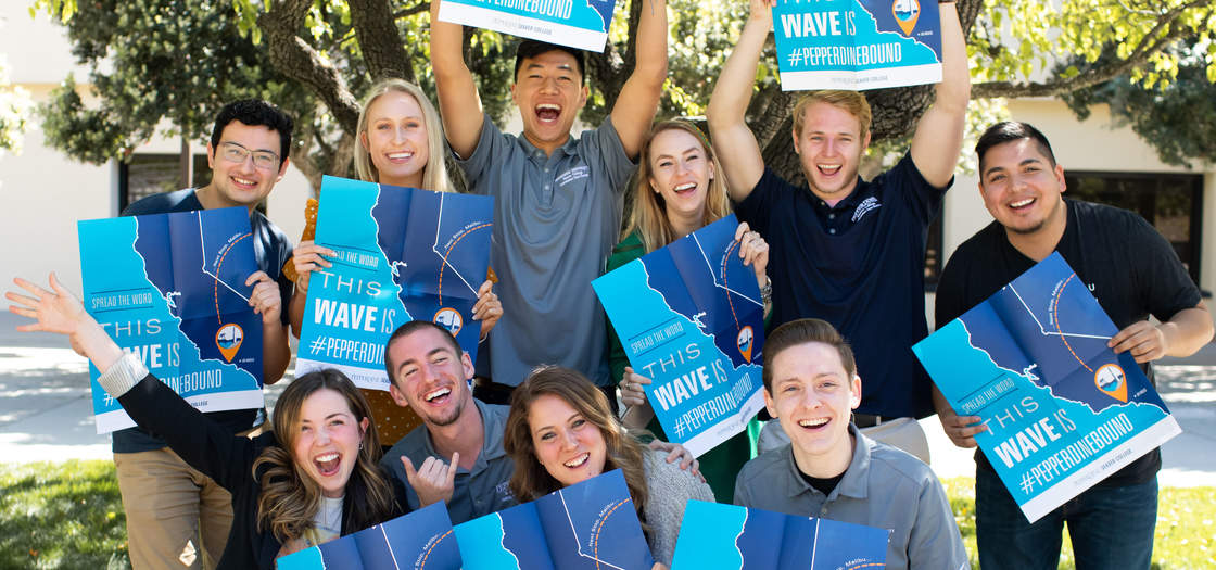 Seaver admission staff holding Pepperdine bound posters