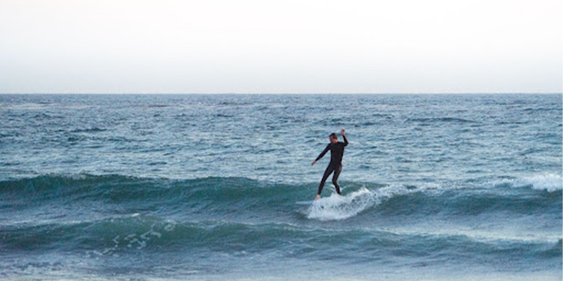 Pepperdine Student surfing at First Point