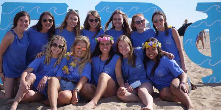 Lanies Jones and her sorority sisters gathered together at the beach wearing matching blue shirts