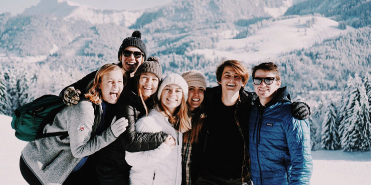 Millie Vieira pictured among snow-covered mountains with a group of Seaver students