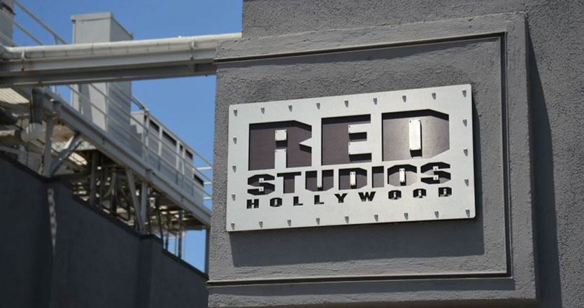 RED Studios sign on a gray concrete wall