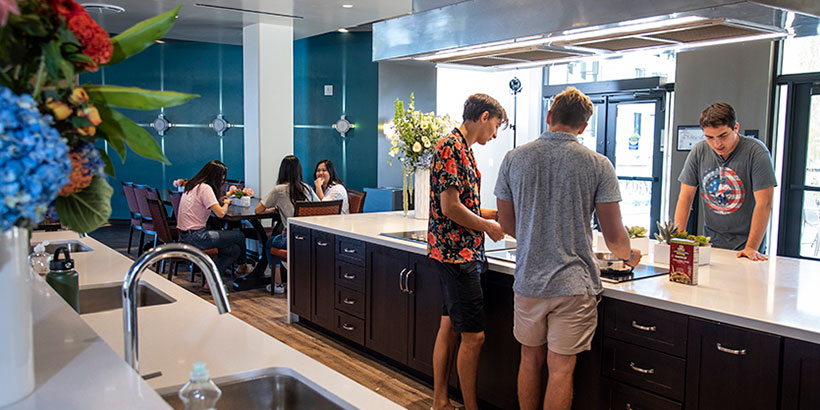 Students in Seaside Hall's community kitchen