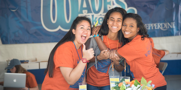 Three female students smiling during Waves Weekend