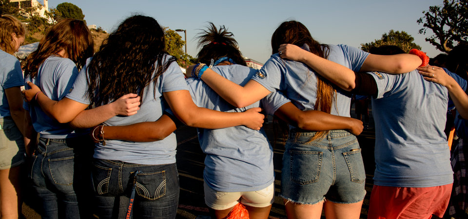 Students embracing in a semi-circle