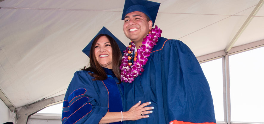 Alumni smile at graduation