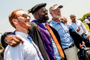 Pepperdine graduate taking a photo with graduation attendees