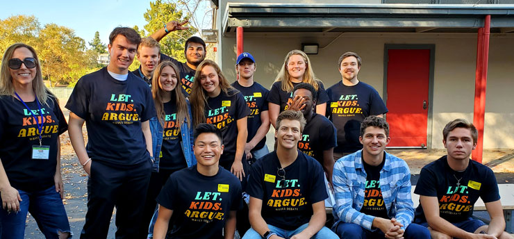 Debate students gathered at an elementary school wearing their "Let Kids Argue" t-shirts