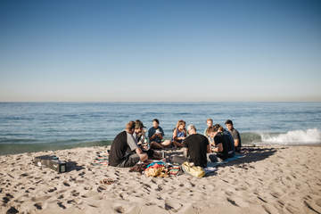 Students sitting on the beach