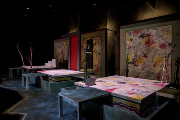 Tables on display in a theatre production in Lindhurst Theatre