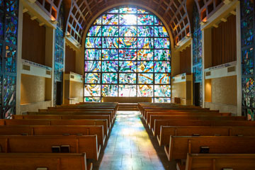 Stained glass and pews in Stauffer Chapel