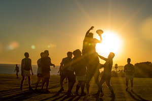 Students playing beach volleyball