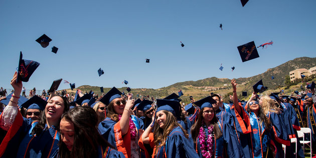 Seaver graduation ceremony-students tossing caps in the air