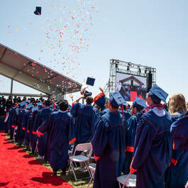Seaver students in graduation robes on Alumni Park