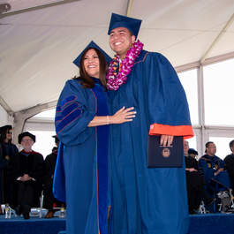Seaver graduate holding his diploma
