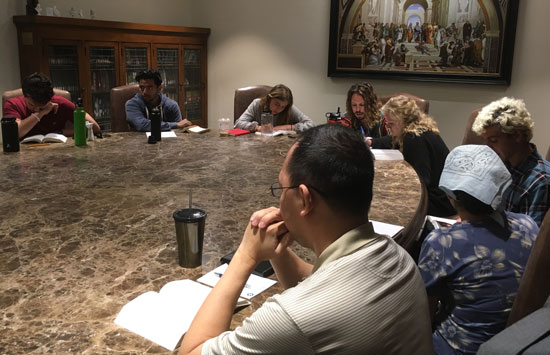 Students gathered at the table in the Great Books Classroom