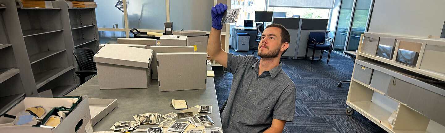 person looking at black and white historical photos