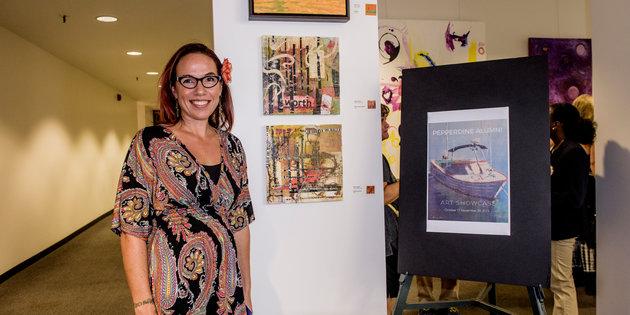 Seaver alumni standing alongside her artwork during Waves Weekend