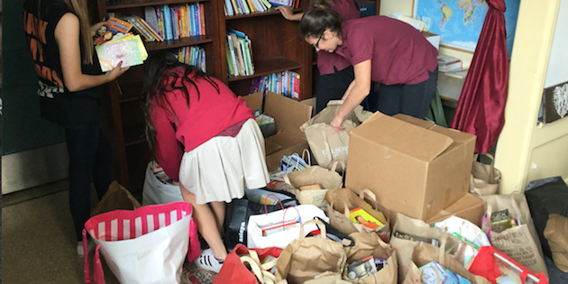 students organizing items into boxes