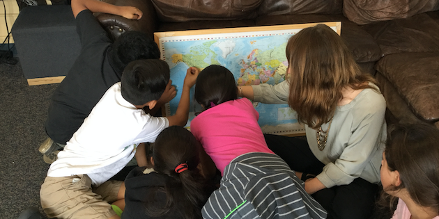 students looking at a wold map