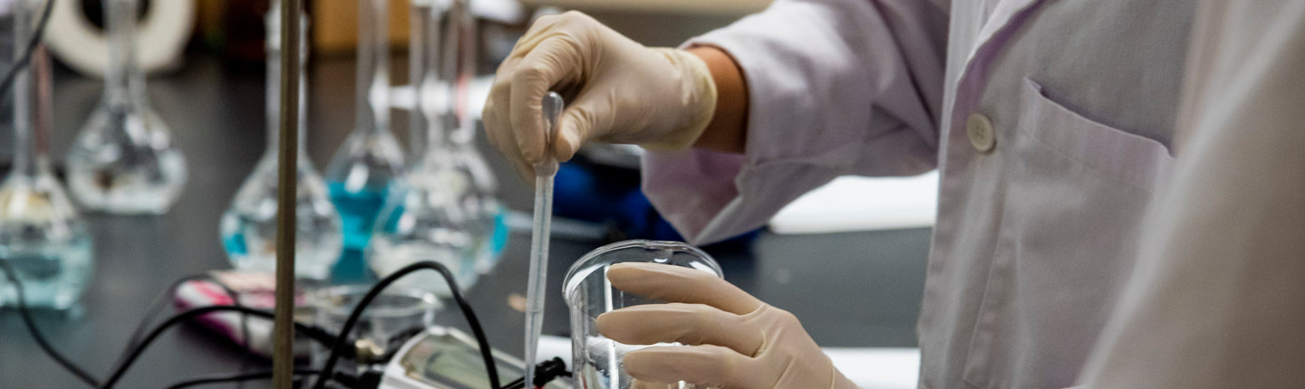 Student mixing chemicals in a lab
