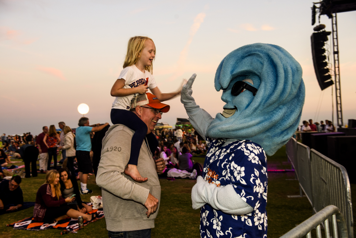 Willie the Wave high-fiving little girl