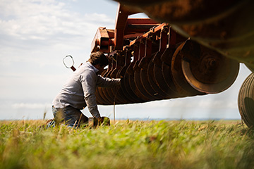 Landon Brady fixing farm equipment 