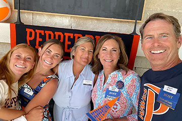 group posing with pepperdine memorabilia